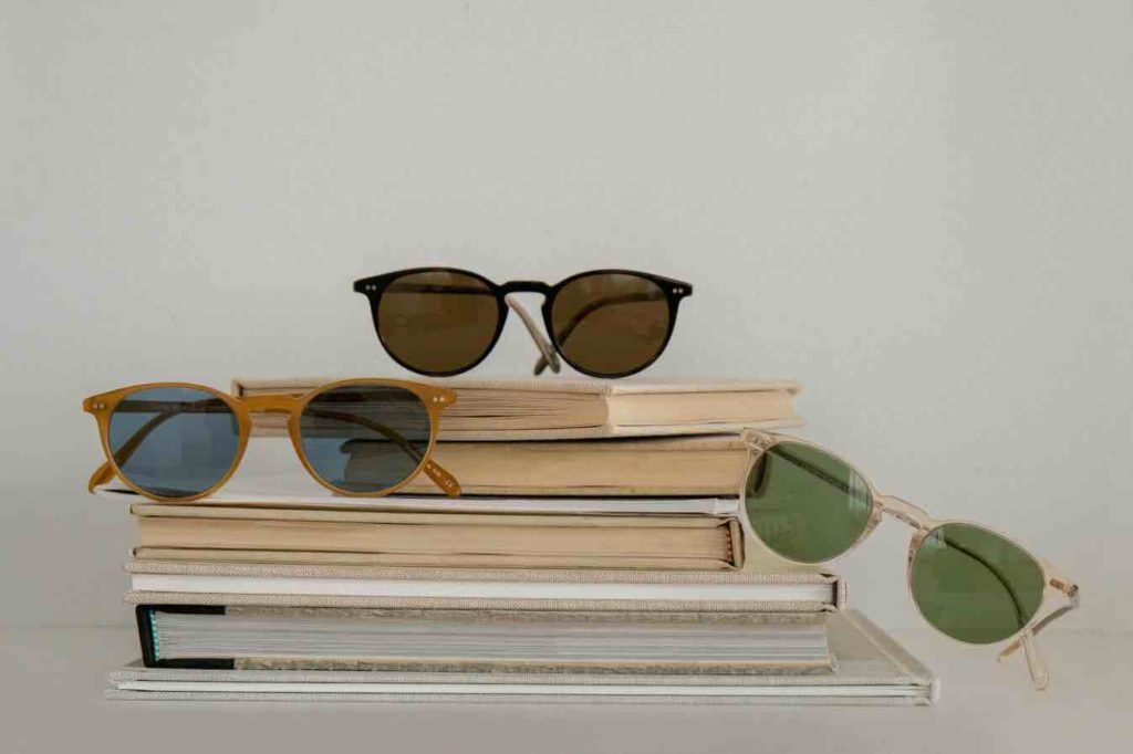 Oliver Peoples Sunglasses on a stack of books